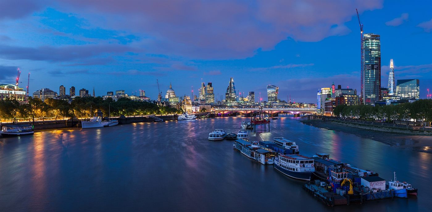 London skyline with a curved glass tower behind a Victorian terrace