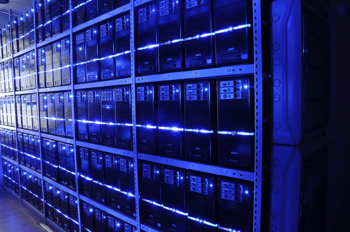 Data centre aisle with illuminated server racks